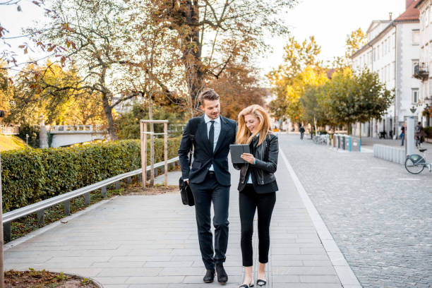 istock Businesspeople using a digital tablet and walking in the city 1045348010