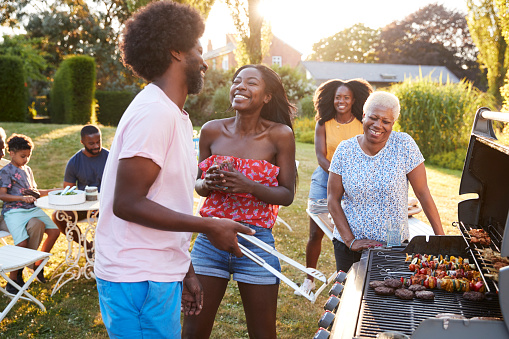 Couple laughing at a multi generation family barbecue