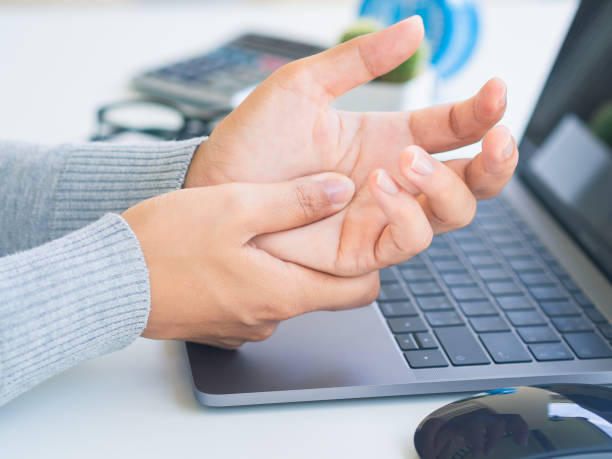 istock Closeup woman holding her hand pain from using computer long time. Office syndrome concept. 1045350662