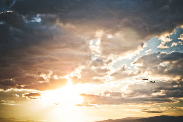 istock Travel, airplanes in sunset sky 1045352454