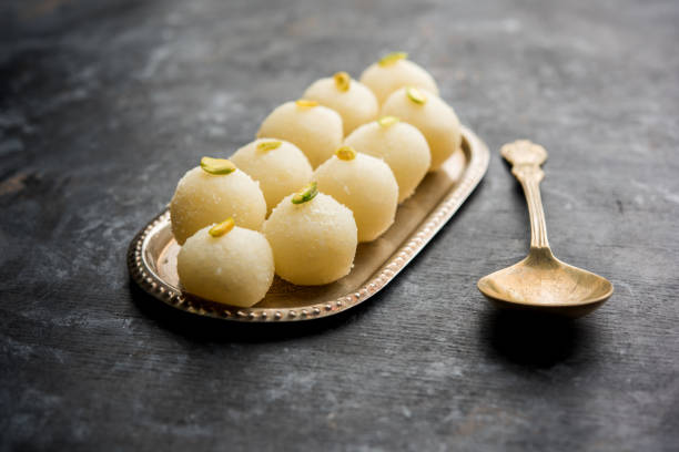 Indian Rasgulla or dry Rosogulla dessert/sweet served in a bowl. selective focus Indian Rasgulla or dry Rosogulla dessert/sweet served in a bowl. selective focus rosogolla stock pictures, royalty-free photos & images