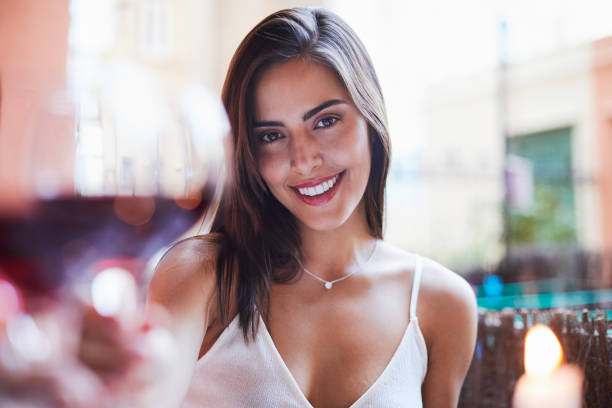 beautiful colombian woman wine toasting pov. - restaurant wine table table for two imagens e fotografias de stock