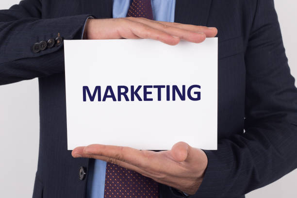 istock Man showing paper with MARKETING text 1045371994