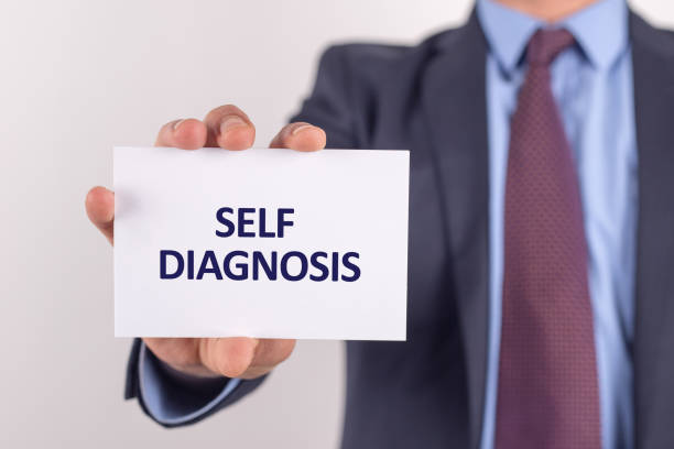 istock Man showing paper with SELF DIAGNOSIS text 1045372678