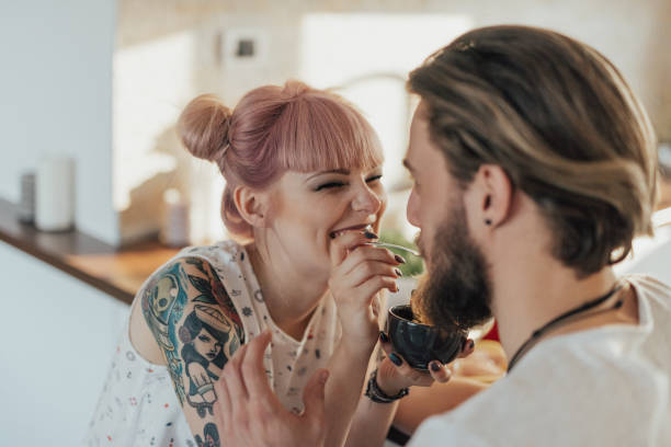istock Cute couple sitting in the kitchen and having dinner 1045377384