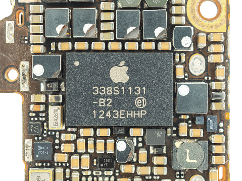 Chiang Rai, Thailand: May 17, 2017 - Close-up image of power management IC chip on old and damaged Apple iPhone 5s logic board. Selective focus