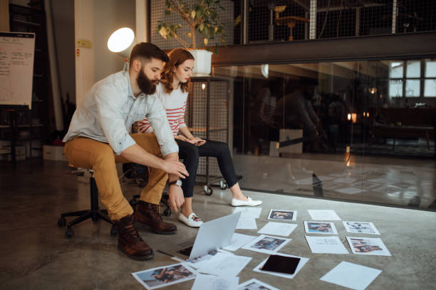 istock Coworkers discussing about new magazine issue 1045383544