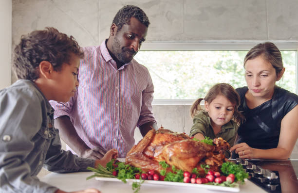 istock Fathers preparing thanksgiving turkey 1045384284