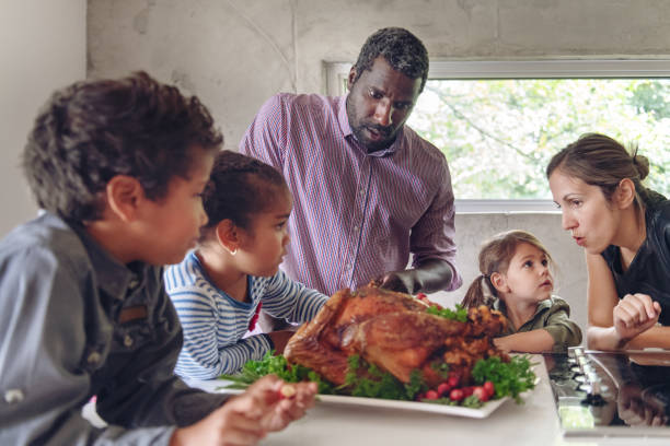 istock Fathers preparing thanksgiving turkey 1045384330