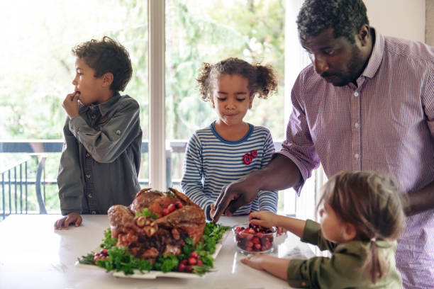 istock Fathers preparing thanksgiving turkey 1045384336