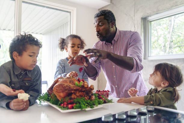 istock Fathers preparing thanksgiving turkey 1045384350