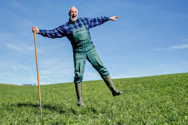 istock Happy farmer takes a break on his meadow. 1045400964