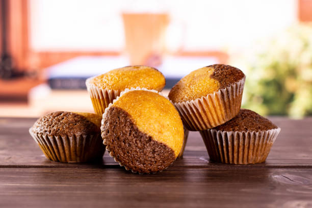 Fresh baked marble muffin with books on window