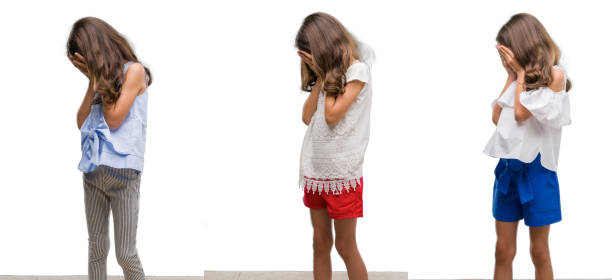 istock Collage of hispanic young child over isolated background with sad expression covering face with hands while crying. Depression concept. 1045402052
