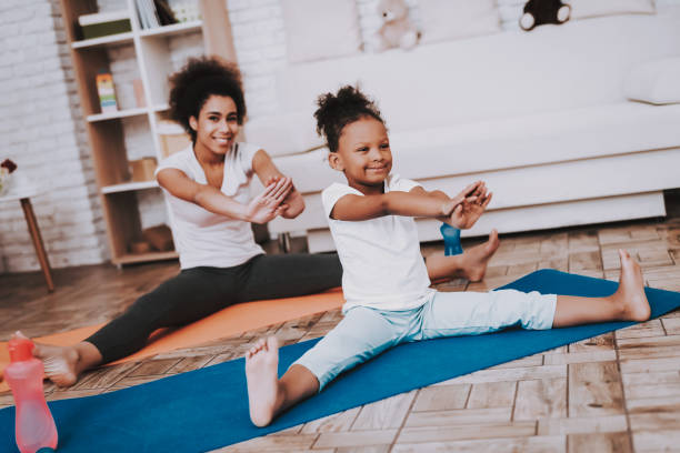 istock Beautiful Mother and Daughter Training Together. 1045402566