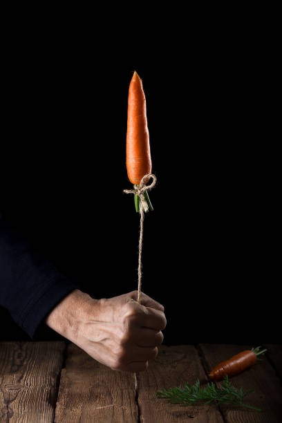 istock Carrot launches like a rocket on black background 1045404768