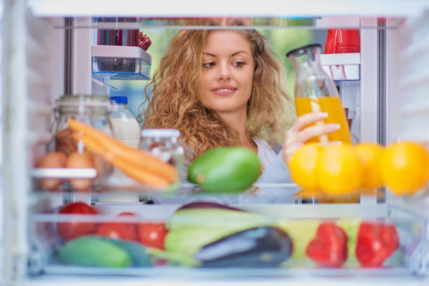 istock Woman taking juice from fridge. 1045408184