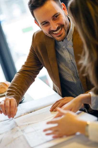 istock Two young architects discussing building plans during a meeting in a modern cafe 1045409248