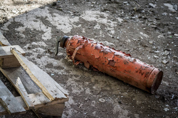 A dirty and rusty fire extinguisher with multiple labels isolated on white. Shot with a 40D w/70-200 f/2.8L