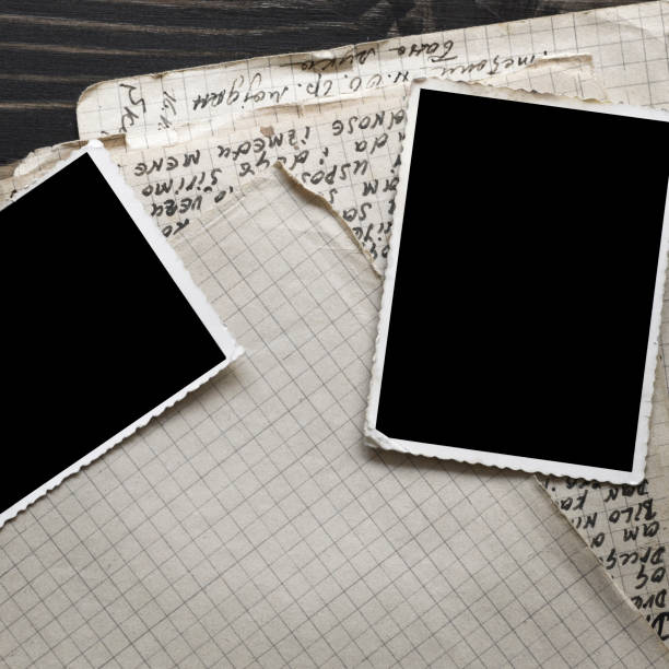 istock Notebook with old frame photo on wood table background 1045414386