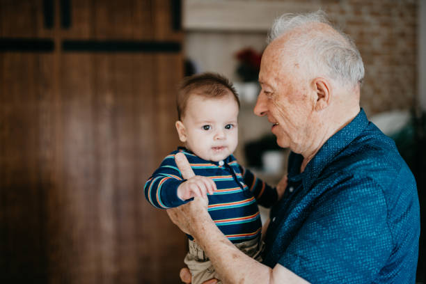 istock Great grandfather embracing his great grandson 1045420076