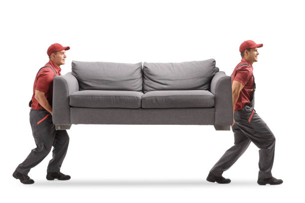 Movers carrying a couch Full length profile shot of two movers carrying a couch isolated on white background carrying stock pictures, royalty-free photos & images