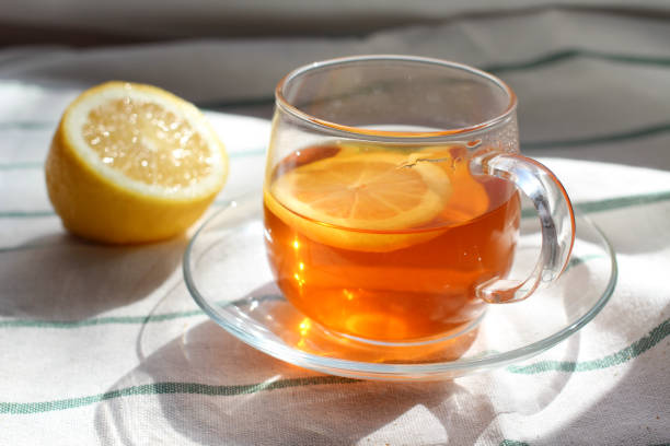 istock transparent Cup of tea with lemon, rye crispbread, natural light, breakfast 1045427184