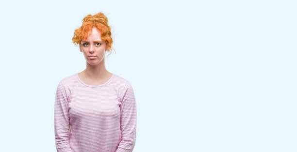 istock Young redhead woman depressed and worry for distress, crying angry and afraid. Sad expression. 1045427488