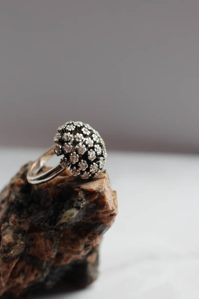 istock silver ring with precious stones on a stone, marble background 1045427592