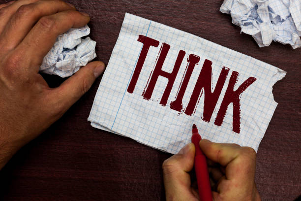 istock Text sign showing Think. Conceptual photo direct ones mind towards someone something have belief or idea Man holding marker notebook page crumpled papers several tries mistakes. 1045432798