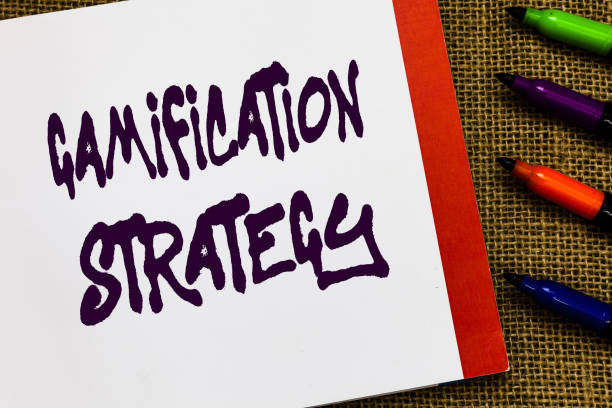 istock Handwriting text Gamification Strategy. Concept meaning use Rewards for Motivation Integrate Game Mechanics Open notebook page jute background colorful markers Expressing ideas. 1045433186