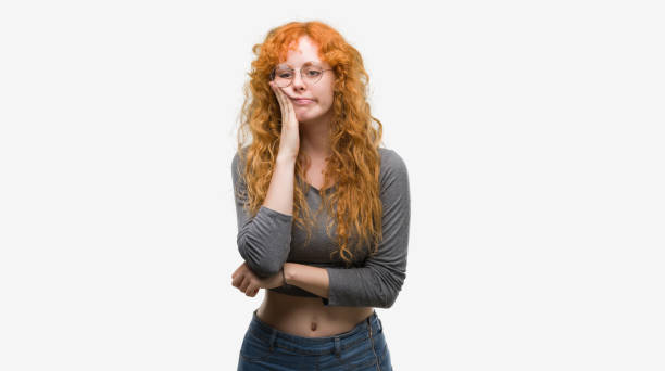 istock Young redhead woman thinking looking tired and bored with depression problems with crossed arms. 1045433508