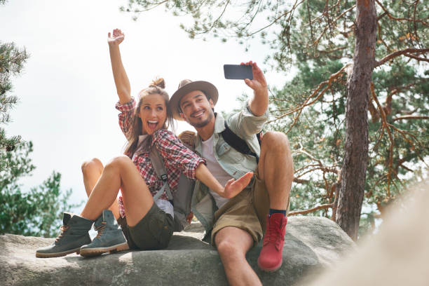 istock Young couple making a selfie during hiking trip 1045433982
