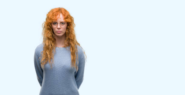 istock Young redhead woman wearing glasses with a confident expression on smart face thinking serious 1045434032