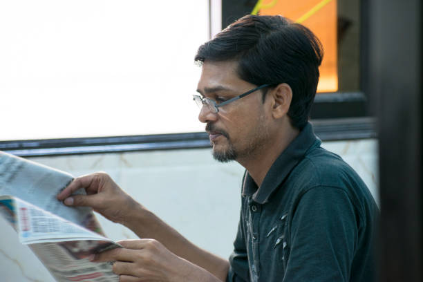 istock young man is reading newspaper  in morning time 1045435280