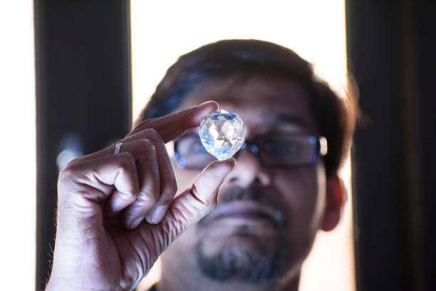 istock young diamond merchant is looking at diamond 1045435376