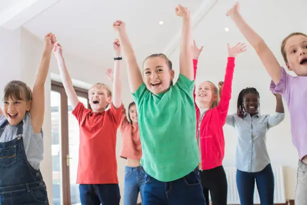 Photo of Group Of Children Enjoying Drama Class Together