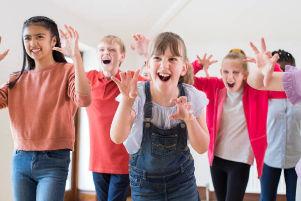 istock Group Of Children Enjoying Drama Class Together 1045439928