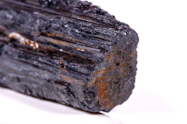 istock macro mineral stone sherle, schorl, black tourmaline on white background 1045444494