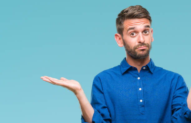 istock Young handsome man over isolated background clueless and confused expression with arms and hands raised. Doubt concept. 1045447682