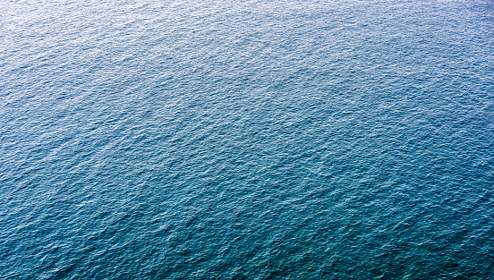 An aerial image of a large area of rippled sea surface off the Italian shore.