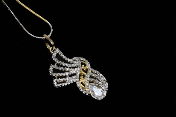 istock Fancy designer Diamond chain pendent closeup macro image on black background 1045454726