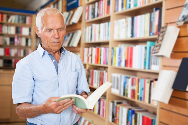 istock man absorbedly searching for interesting books 1045454824