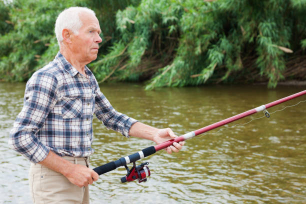 istock Mature man angling at riverside 1045455142