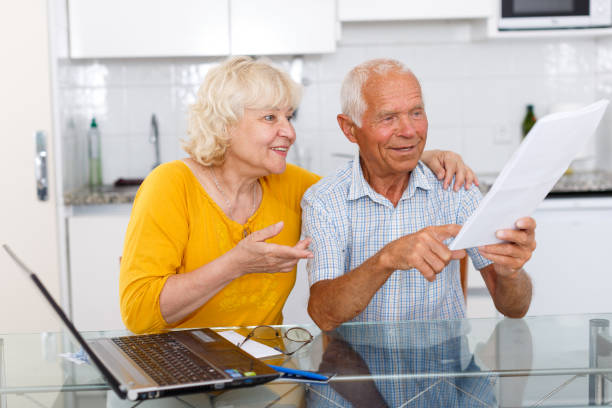 istock Smiling senior man and woman with financial documents 1045455348