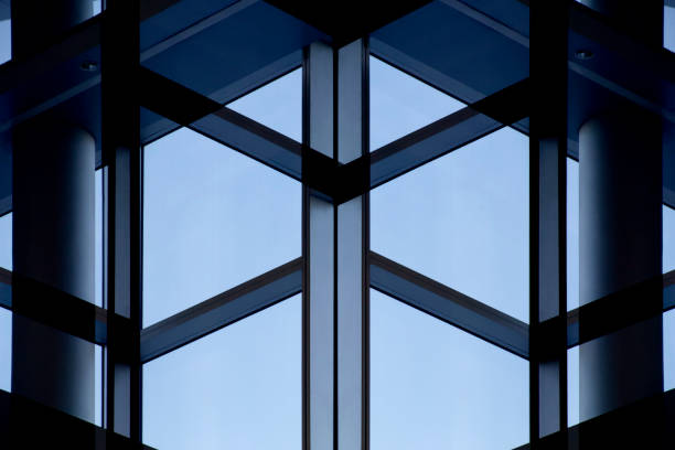 istock Sky visible through transparent glass wall fragment with metal framework. Computer graphic image of futuristic architecture fragment. 1045458082