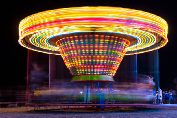 istock Fun-fair at long exposure. Light trails motion. Carousel lights and movements. Fun, lifestile concept. 1045458936