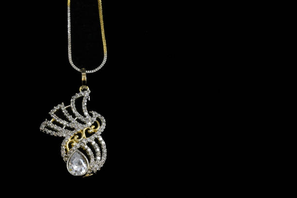istock Fancy designer Diamond chain pendent closeup macro image on black background 1045459098