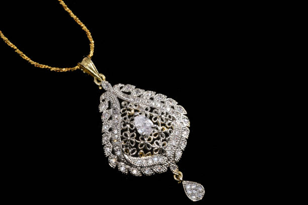 istock Fancy designer Diamond chain pendent closeup macro image on black background 1045459418