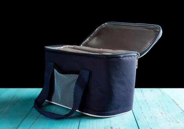istock side view grey and blue lunch pack carrier with the top opened on a wood table on black background 1045462720